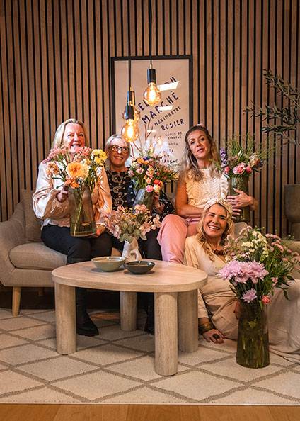 Vrouwen zitten op een bank met bloemen