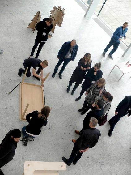 Two young designers show how their tables can be assembled completely without the need for tools - the table is simply assembled using a harness.
