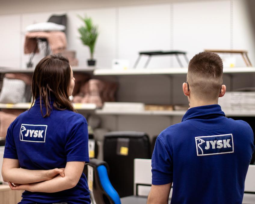 Deputy Store Manager Mikolaj Placzek and Alia observes the placement of the products