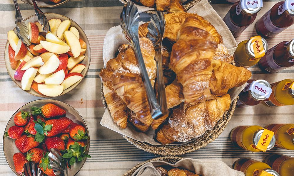 Fikabordet i närbild. Croissanter, smothies och jordgubbar.