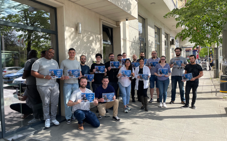 A group of people standing together with a diploma
